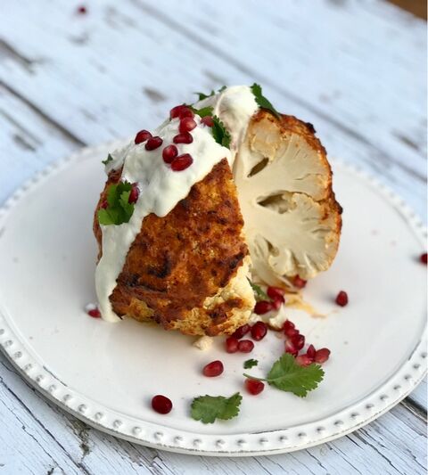 Whole Harissa Roasted Cauliflower with Yogurt & Pomegranate seeds